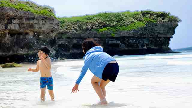 梅雨明け後のイベント・アクティビティを楽しむ準備をしよう！子供とp母さんがビーチで遊んでいる画像